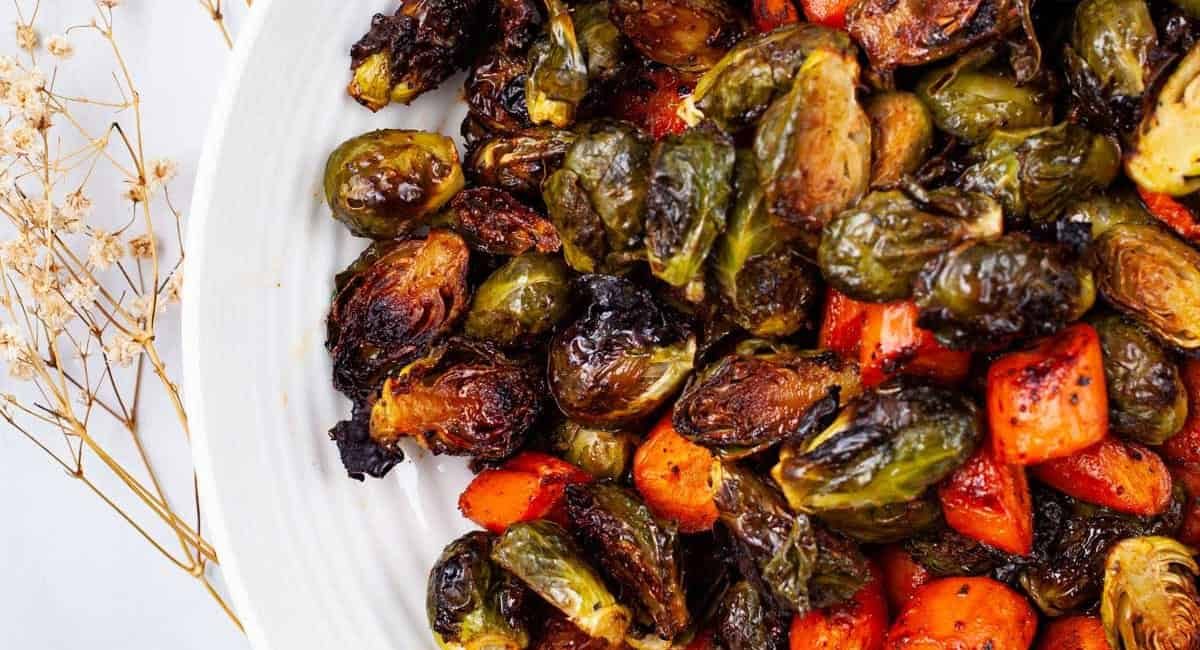 Overhead image of sweet & spiced roasted brussels sprouts and carrots.