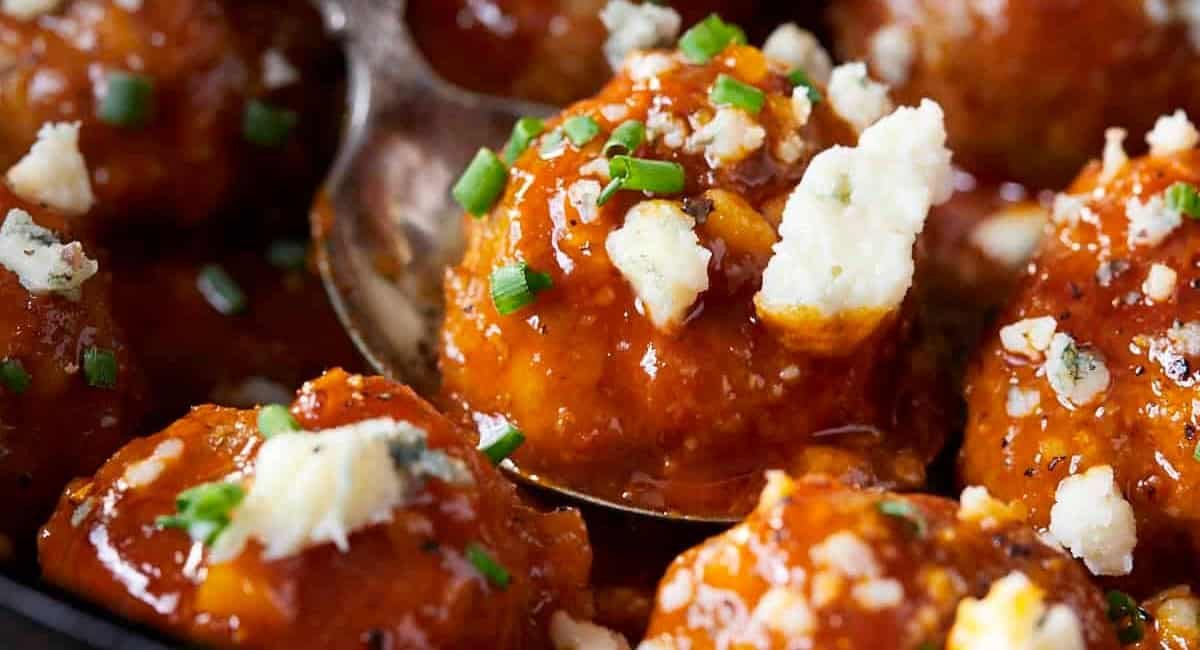 Up close image of buffalo chicken meatballs with honey garlic buffalo sauce.