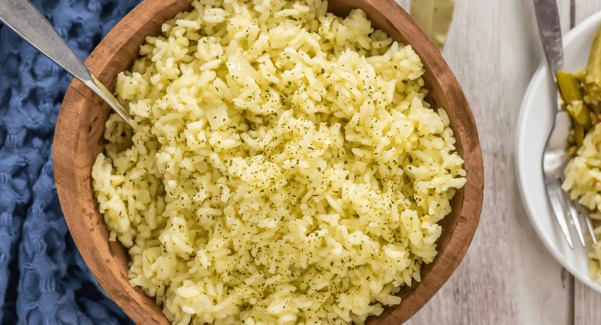 Overhead image of Butter Rice with garnish in brown bowl.