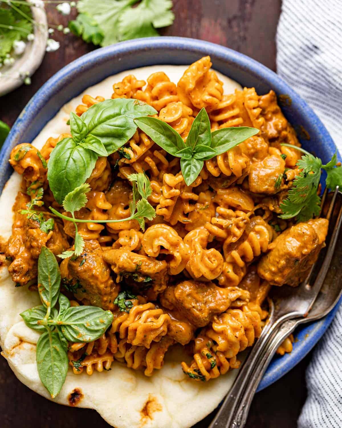 Up close image of butter chicken pasta with garnish.