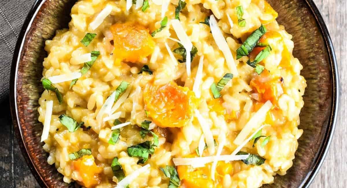 Overhead image of roasted butternut squash risotto with garnish.