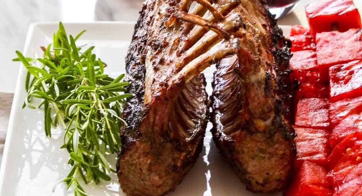 up close image of cabernet rosemary grilled rack of lamb with grilled watermelon skewers.