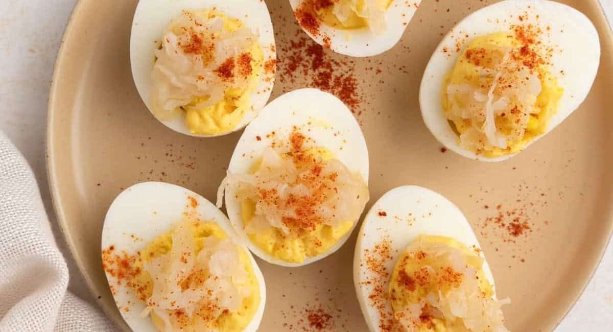 Overhead image of cajun deviled eggs with garnish.