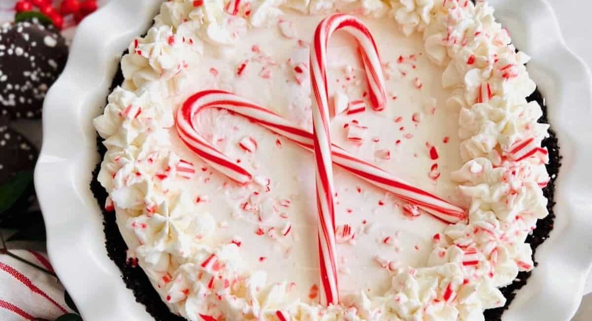 Overhead image of candy cane pie on white dish.