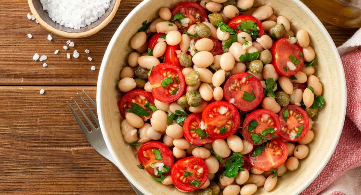 Overhead image of cannellini bean salad with garnish.