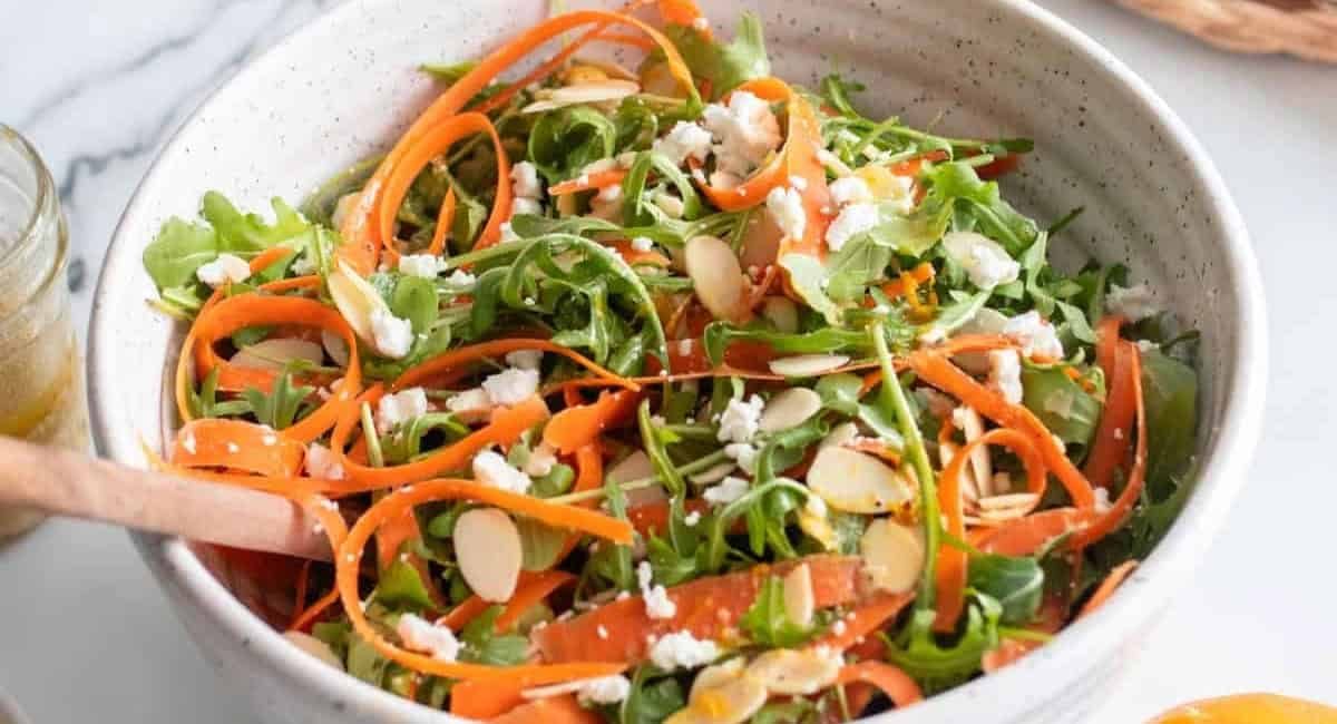 Overhead image of carrot ribbon salad with arugula.