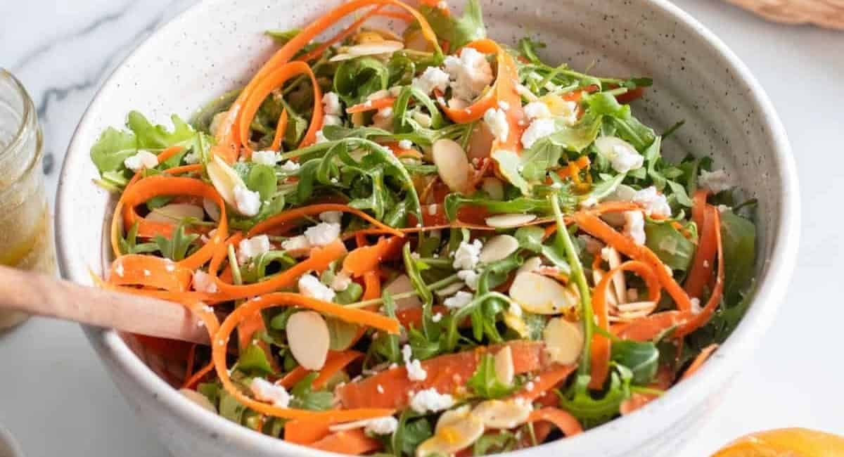 Overhead image of carrot ribbon salad with arugula.