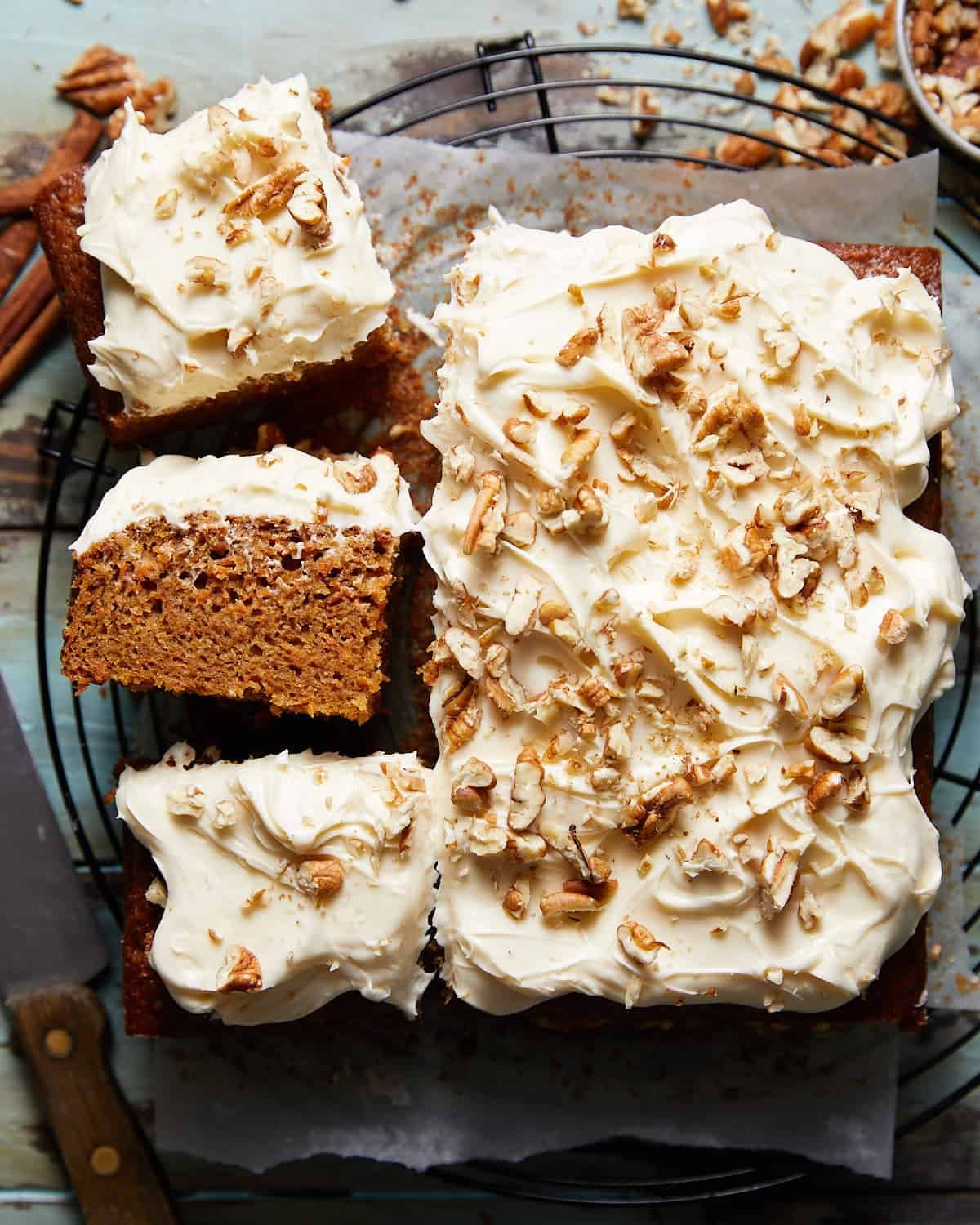 Overhead image of carrot snack cake with frosting and garnish.