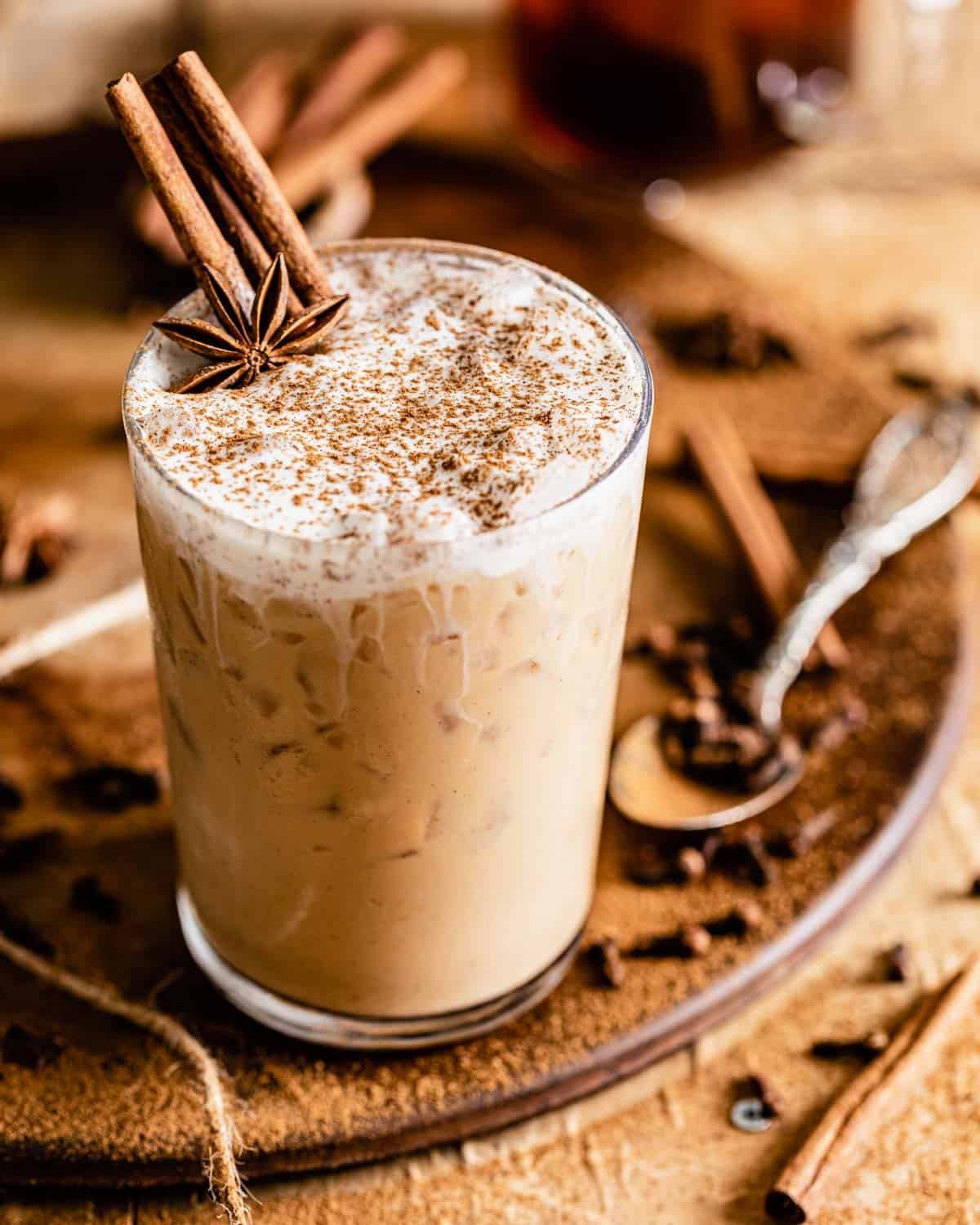 iced chai latte with whipped cream and cinnamon on top