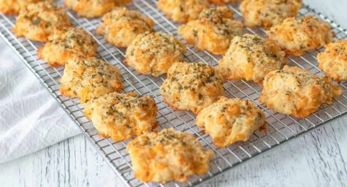 Up close image of cheddar bay biscuits on cooling rack.
