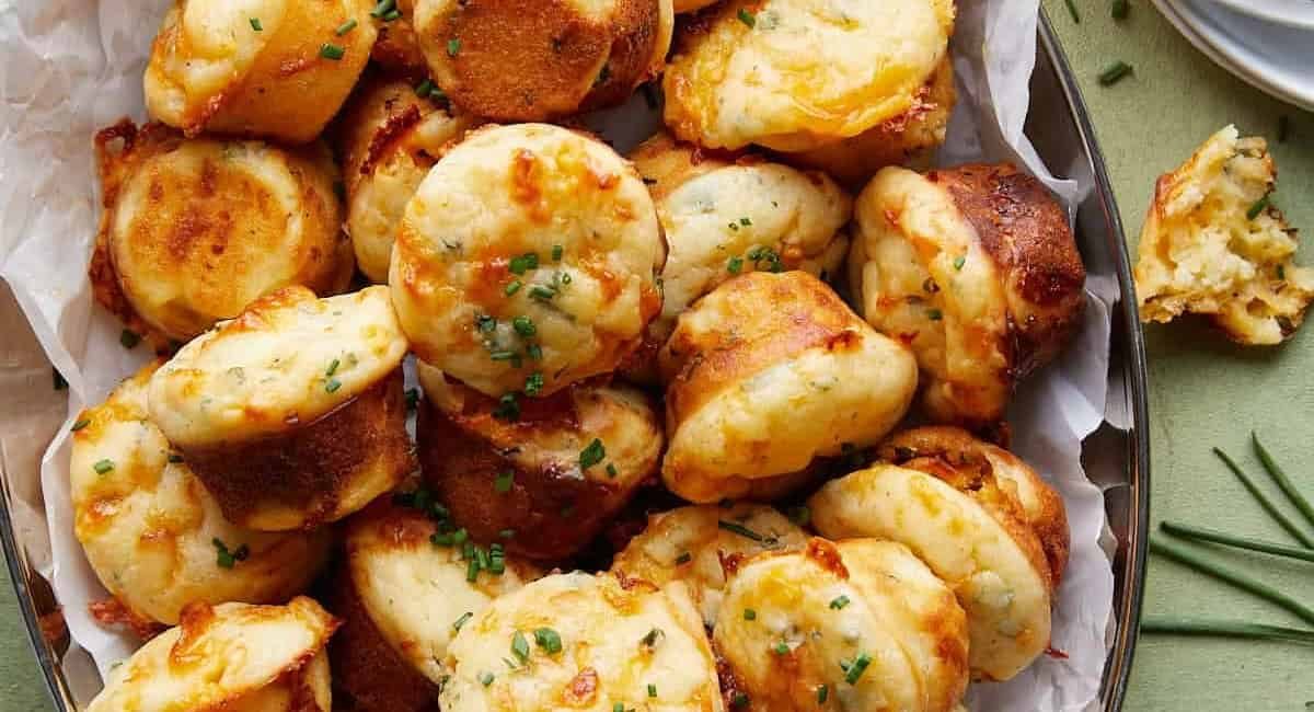 Overhead image of cheddar chive muffins with garnish.