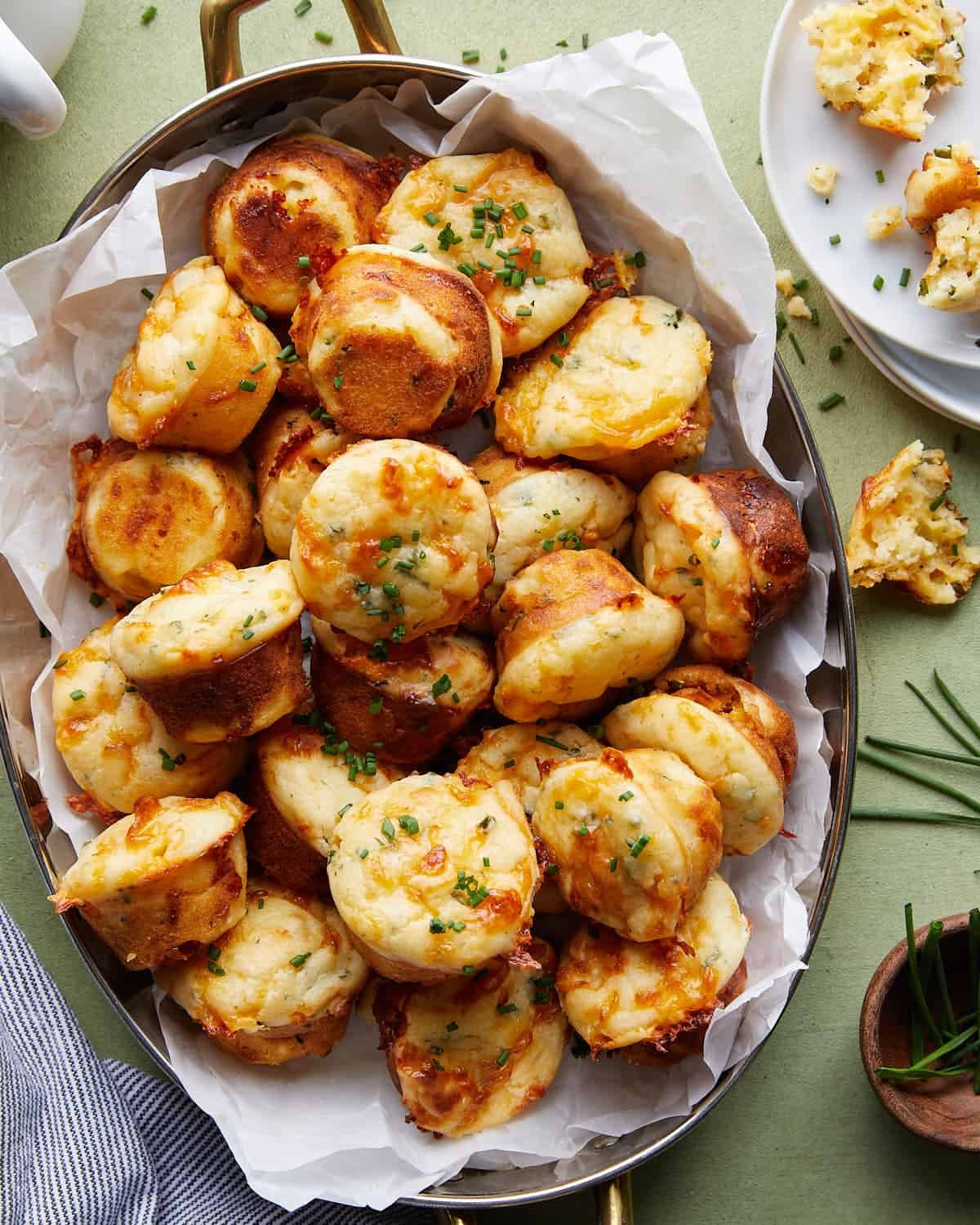Overhead image of cheddar chive muffins with garnish.