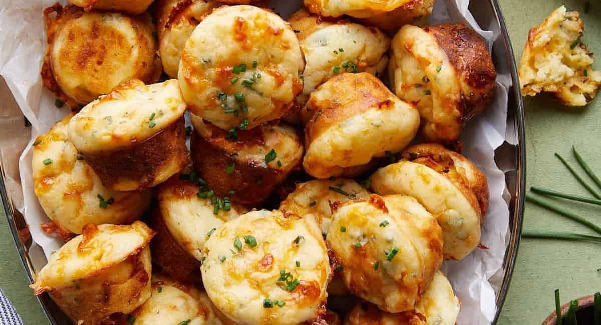 Overhead image of cheddar chive muffins with garnish.