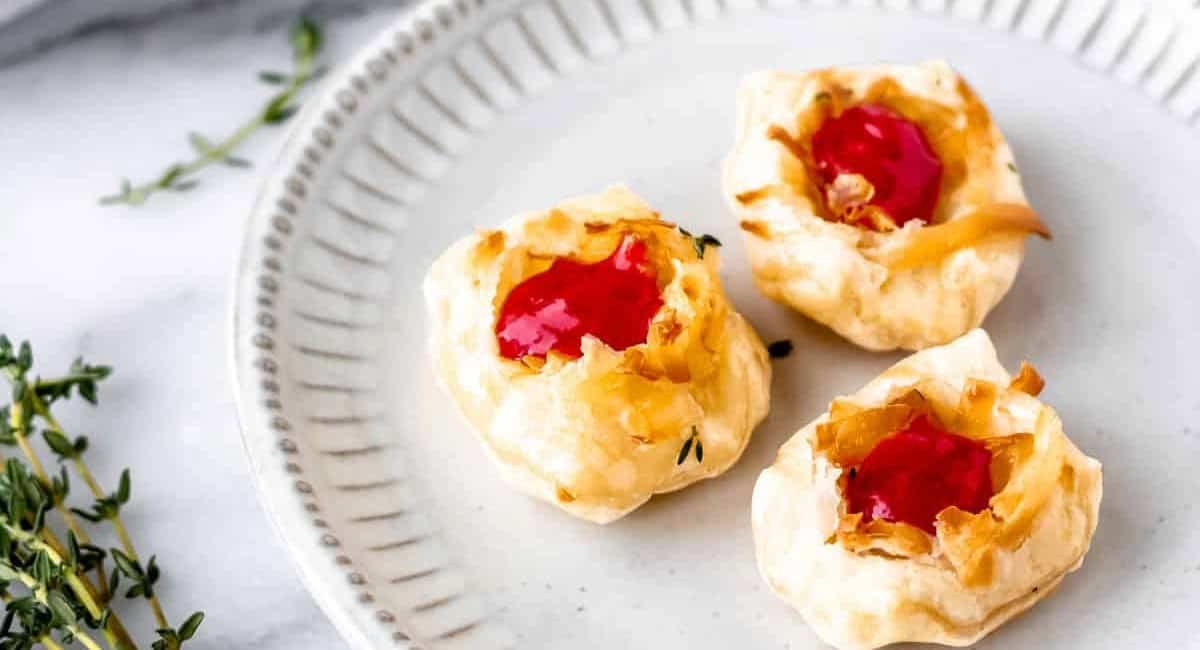 Overhead image of savory gruyere cheese puffs with raspberry sauce and puff pastry.