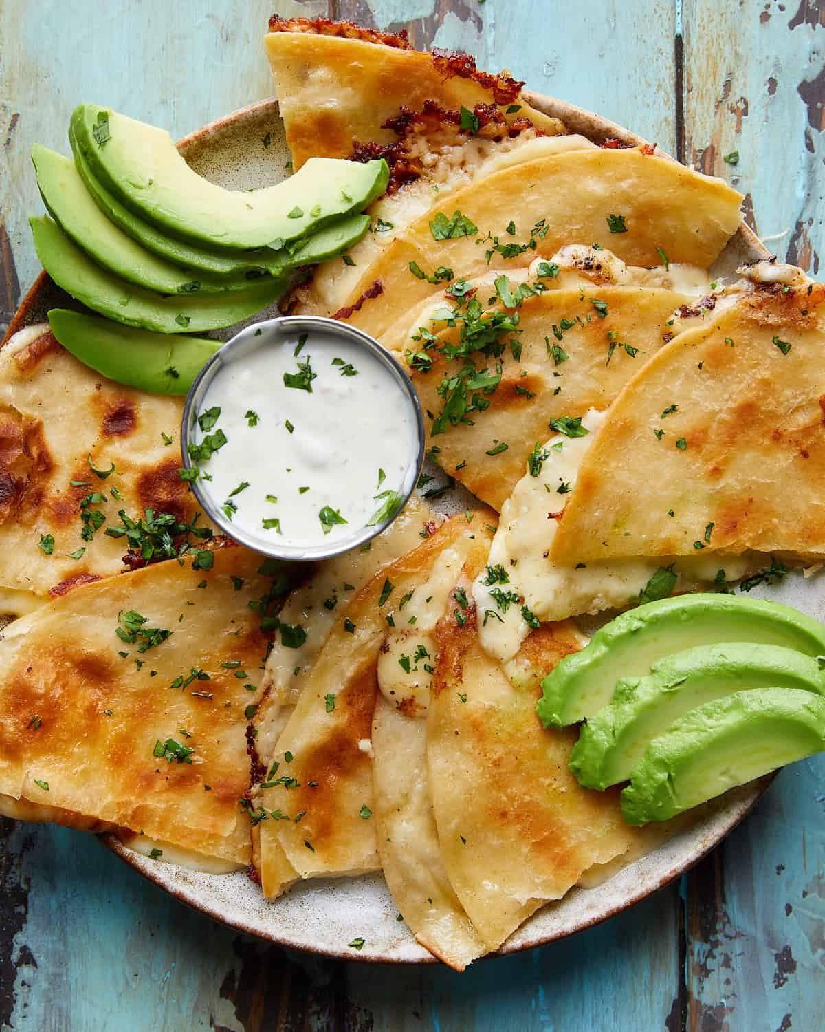 Overhead image of cheese quesadilla with garnish.