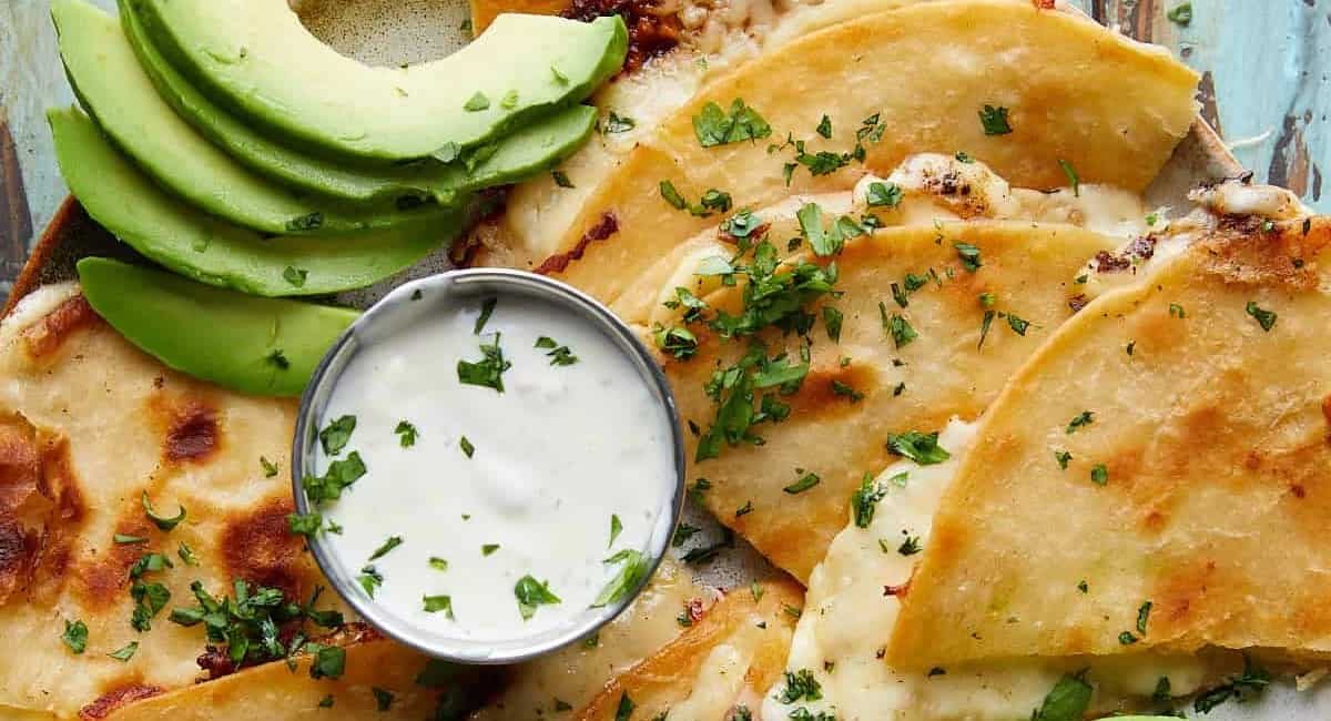 Overhead image of cheese quesadilla with garnish.
