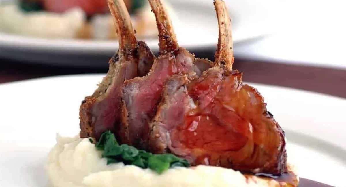 Up close image of rosemary parmesan crusted lamb racks with mashed potatoes.