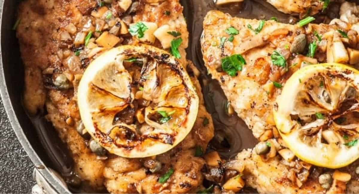 Overhead image of easy healthy chicken piccata with garnish.