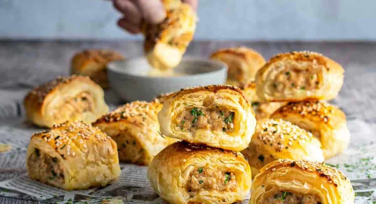 Up close image of chicken sausage rolls made with puff pastry.