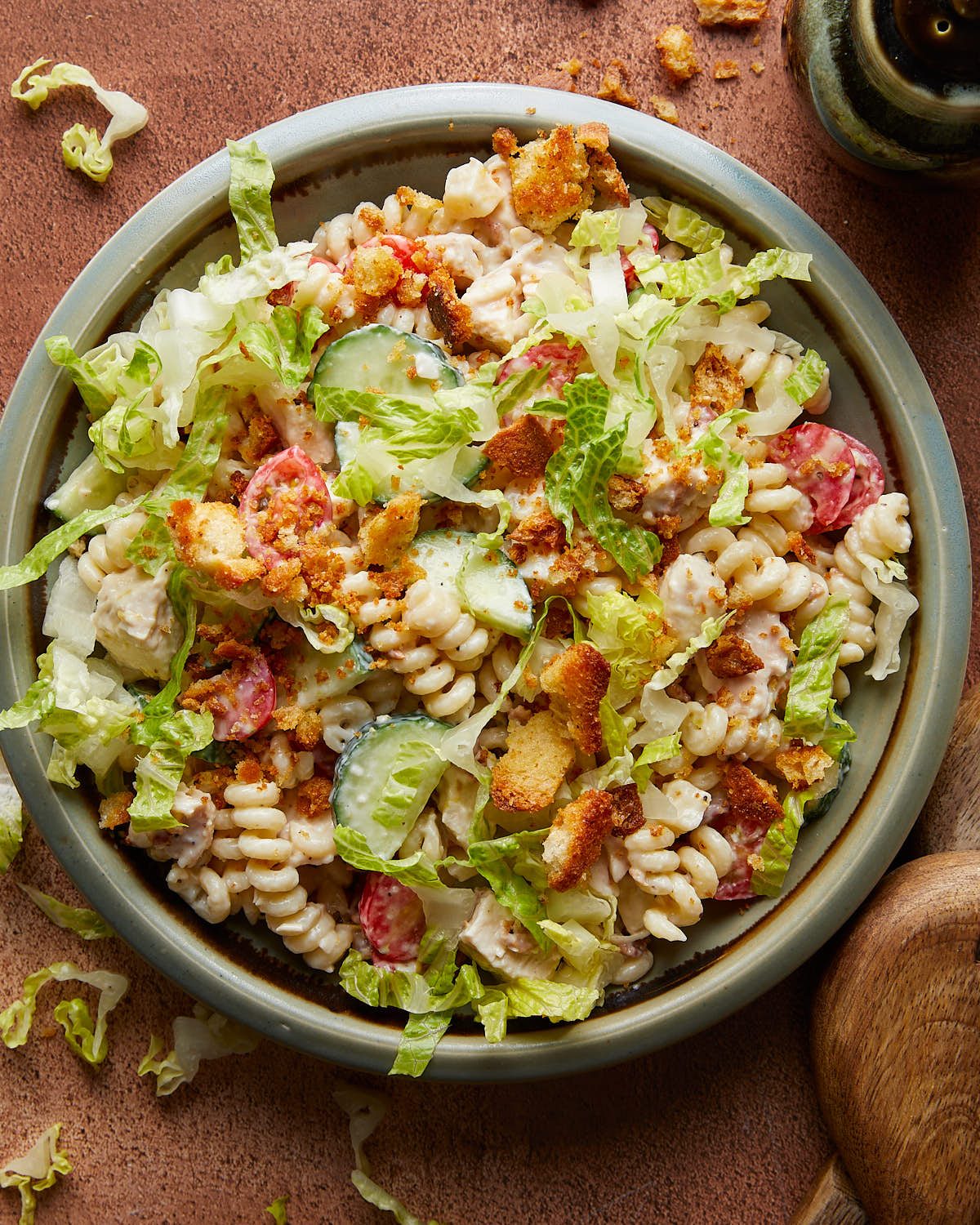 Overhead image of chicken caesar pasta salad in blue dish.
