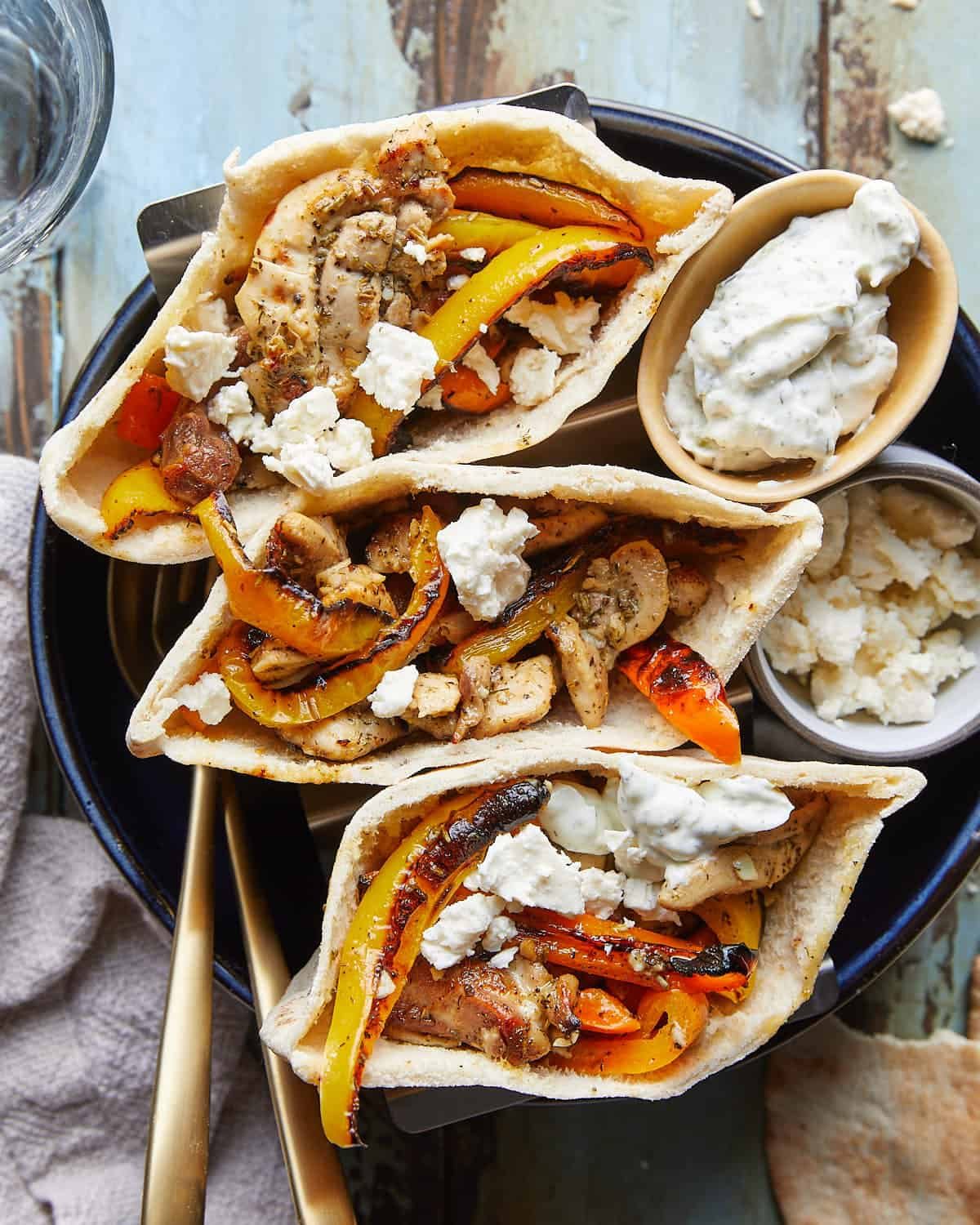 Overhead image of chicken pita pockets with garnish.