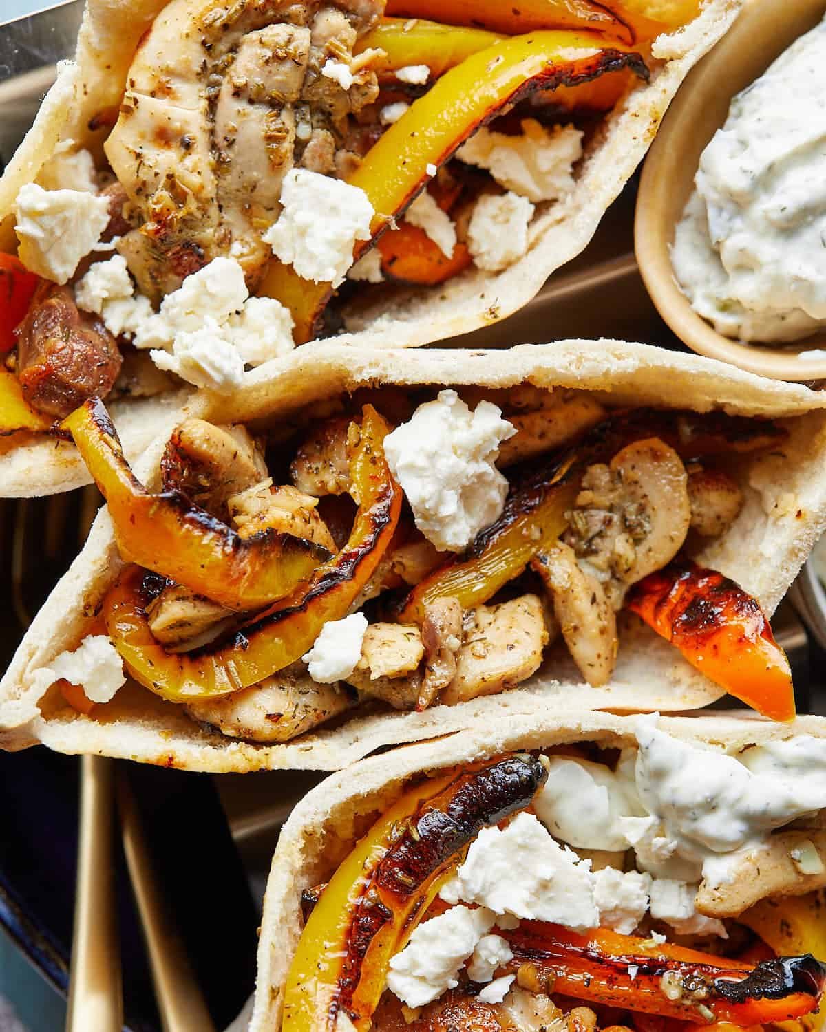 Up close image of chicken pita pockets with garnish.