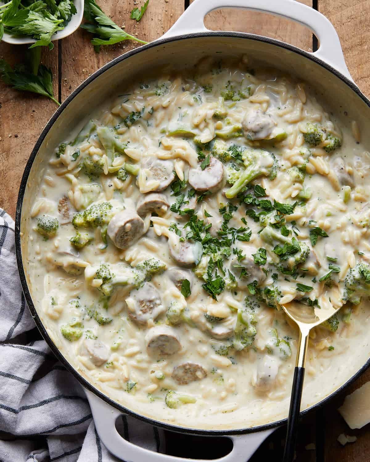 Overhead image of chicken sausage orzo in white pan.