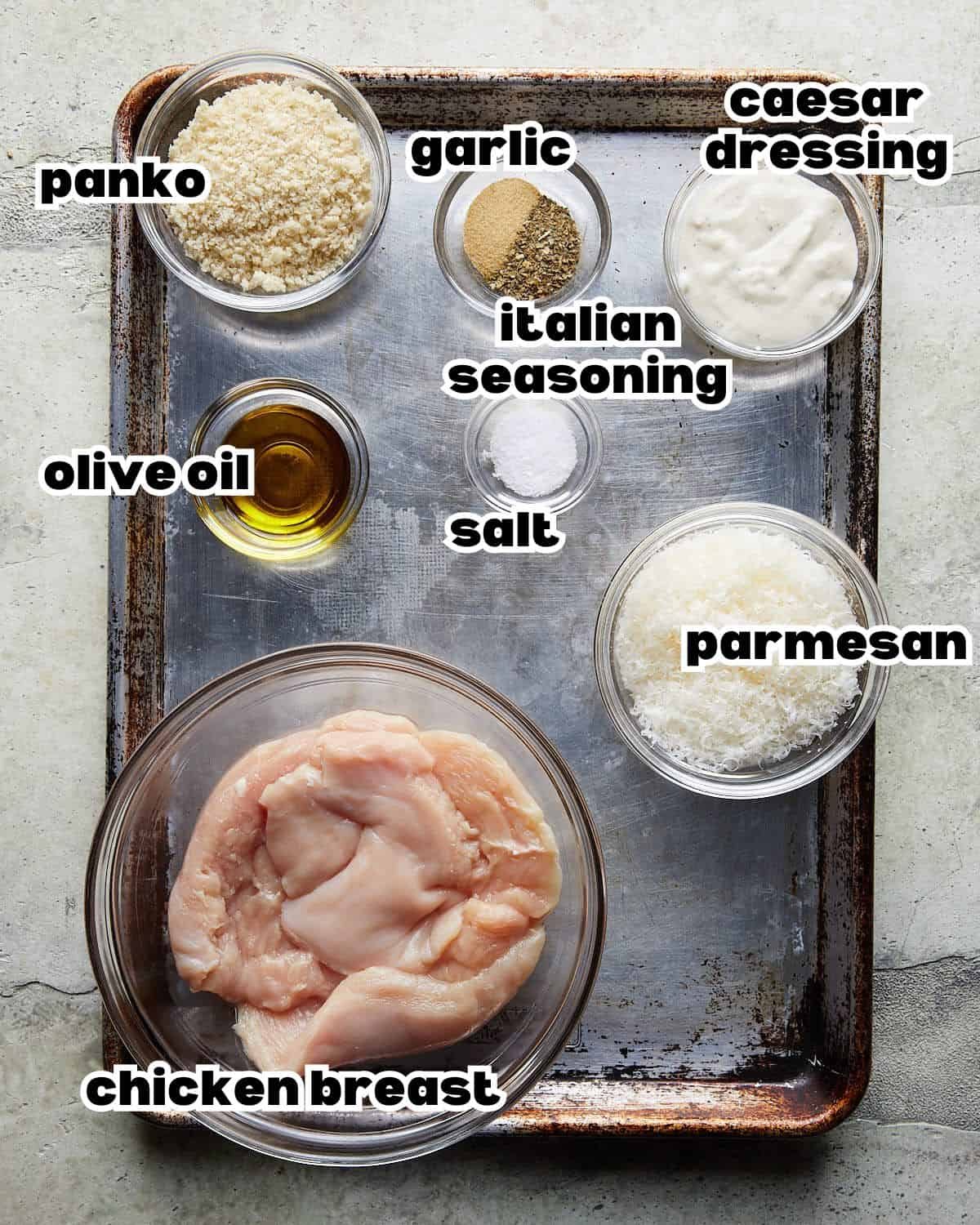 Chicken breasts, panko, Parmesan, Caesar dressing, olive oil, garlic, Italian seasoning, and salt for baked panko chicken.