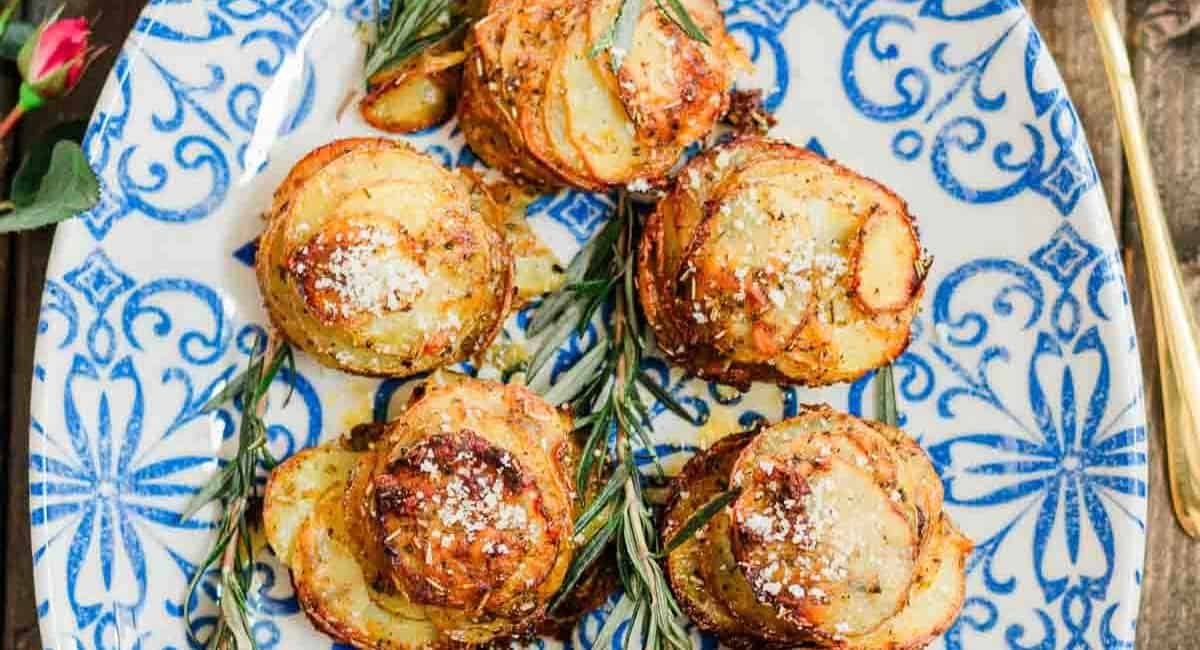 Overhead image of chipotle herbs muffin tin potatoes on blue and white dish.