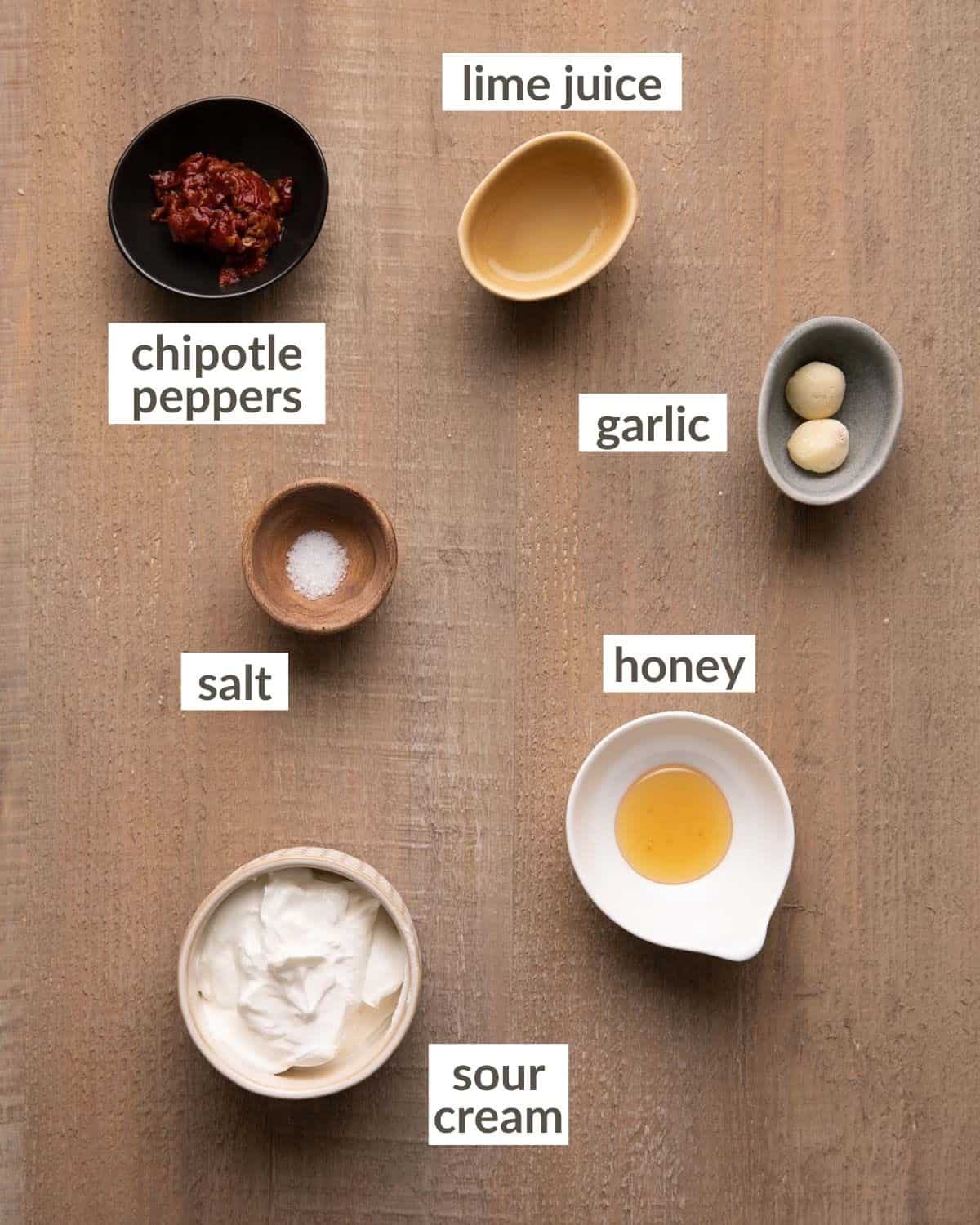 Overhead shot of ingredients for chipotle crema in bowls.