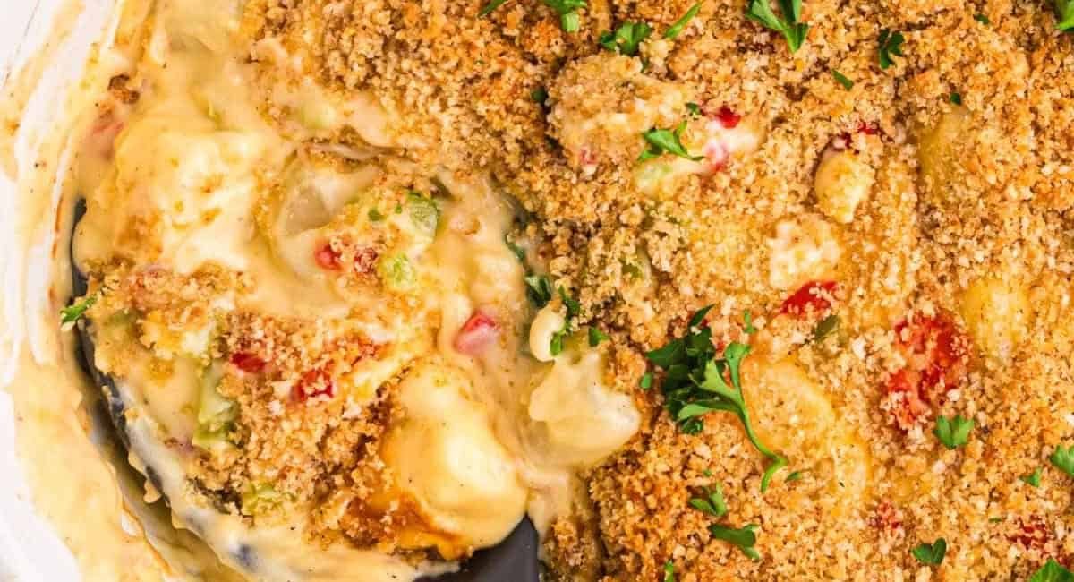 Up close image of cheesy Christmas potatoes recipe with garnish.