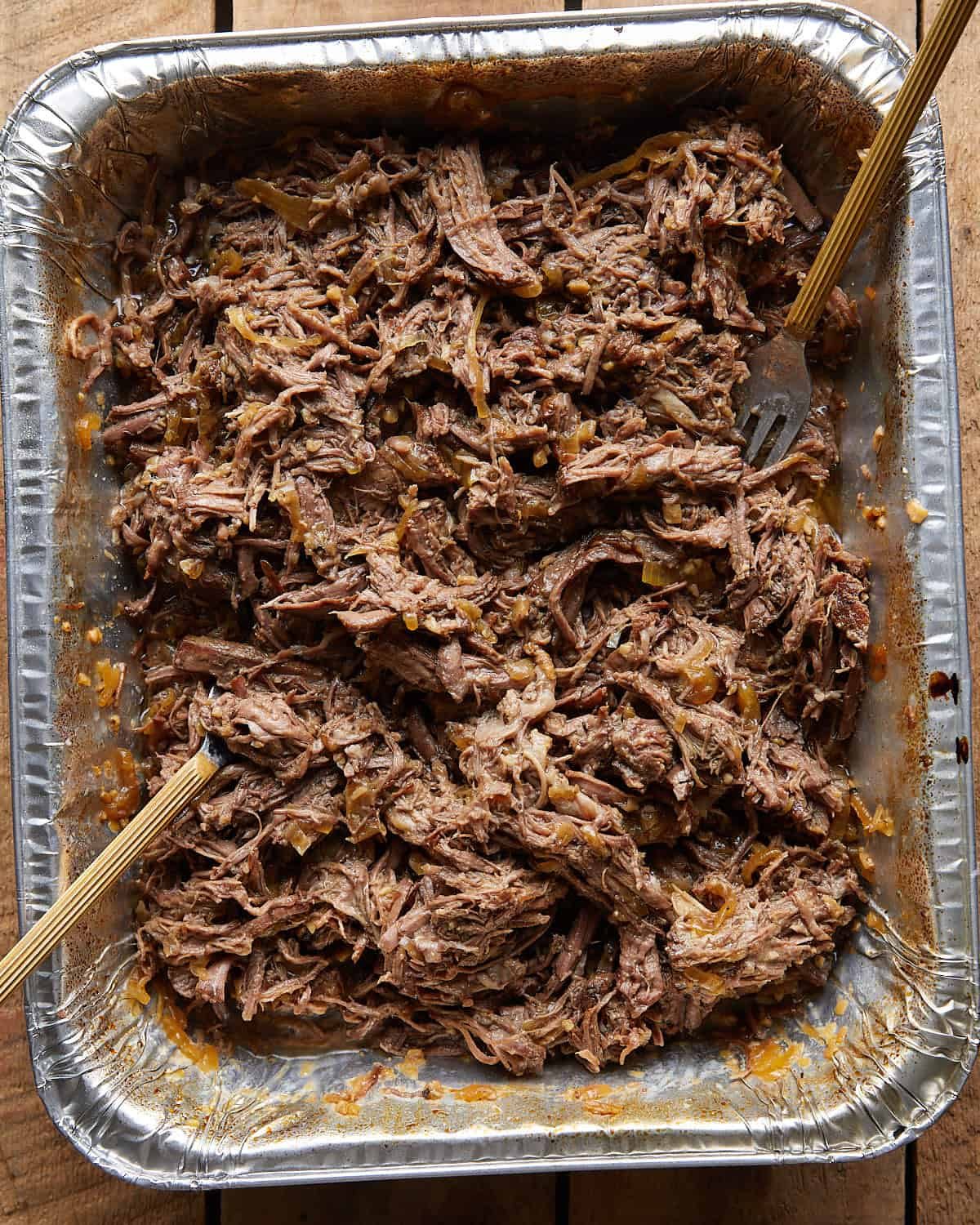 Overhead image of shredded chuck roast in oven recipe.