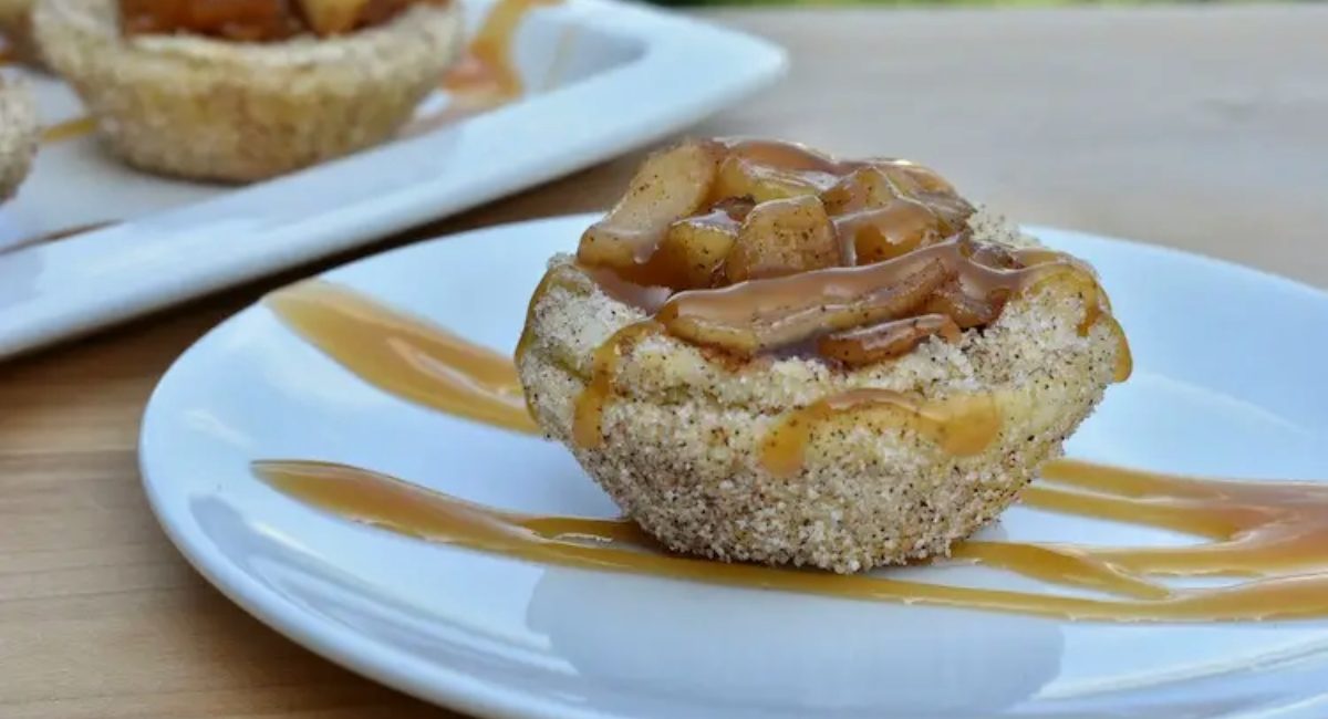 Side profile image of churro apple tartlets.