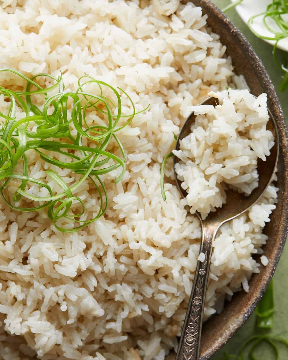 Up close overhead image of coconut jasmine rice with garnish.