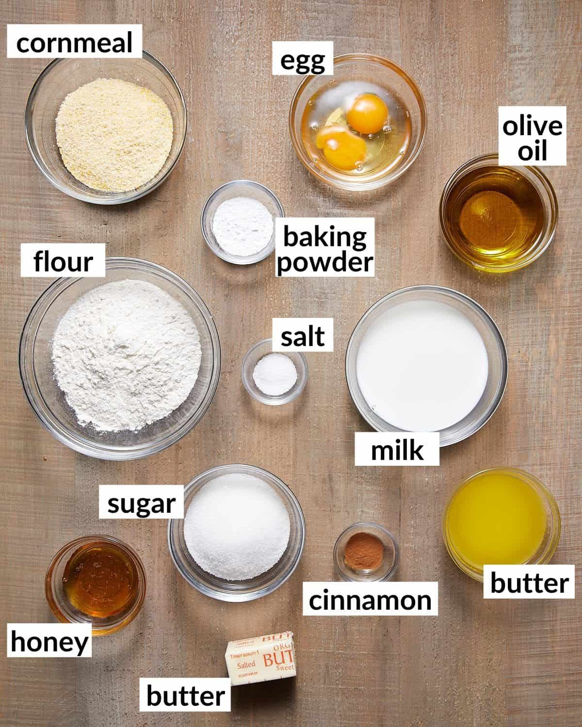 Ingredients needed to make cornbread without buttermilk in glass bowls.