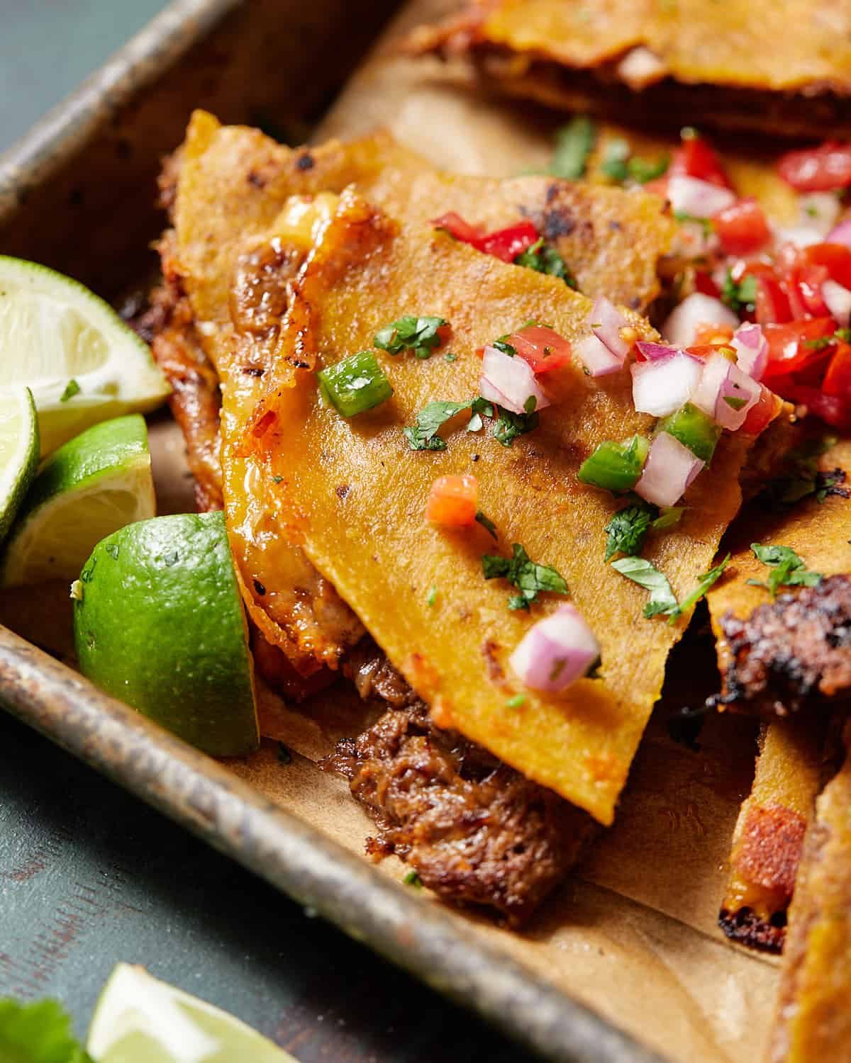 Shows an up close shot of a piece of the finished corn tortilla quesadilla.