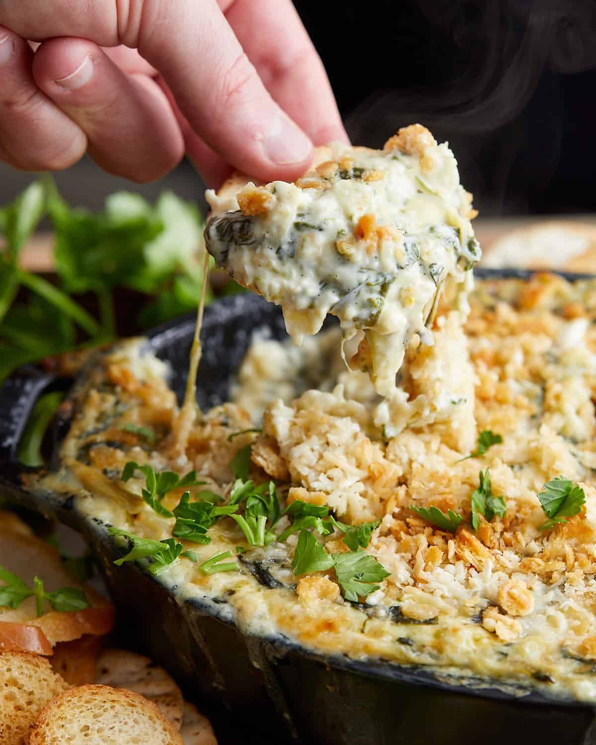 Up close image of crab spinach artichoke dip.