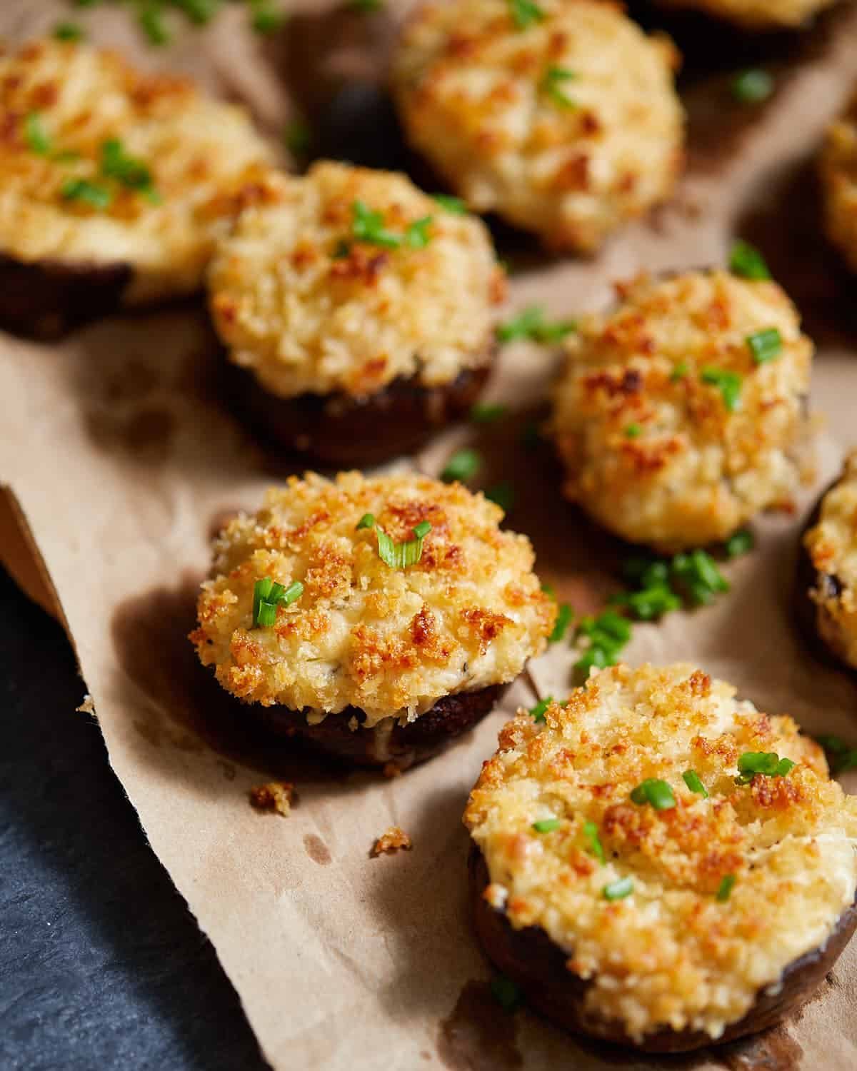 Overhead up close image of cream cheese stuffed mushrooms with garnish.