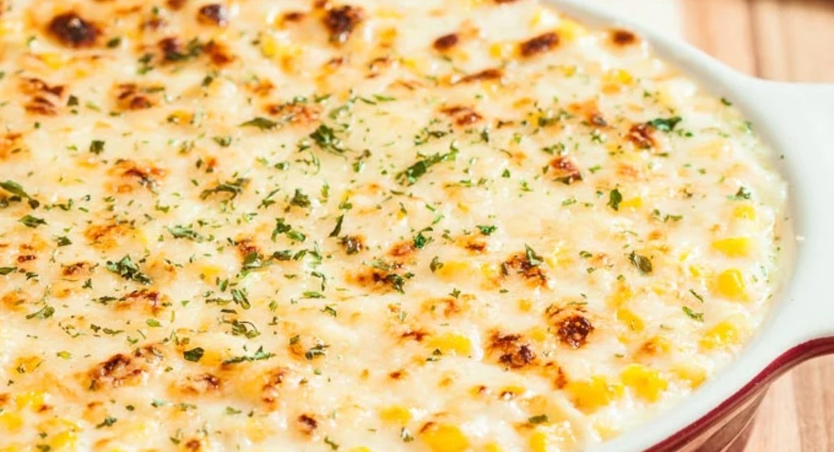 Up close image of creamed corn au gratin with garnish.