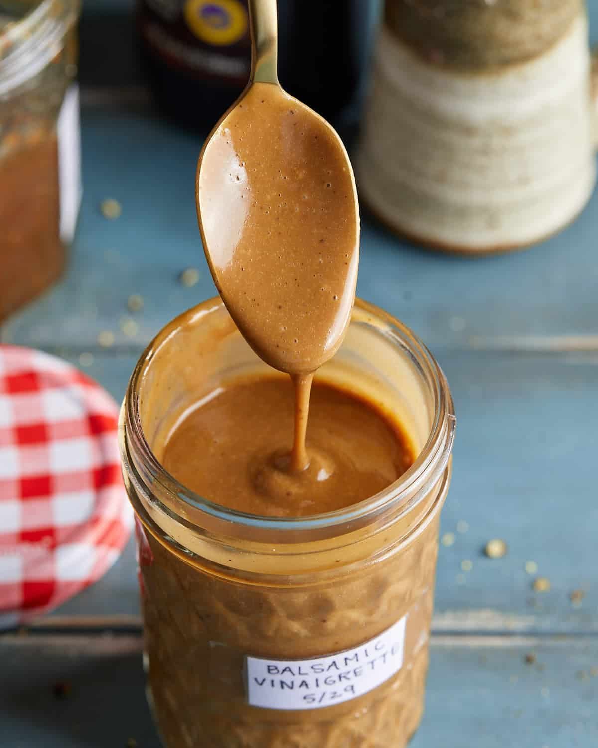 Up close image of creamy balsamic vinaigrette dressing in glass jar.