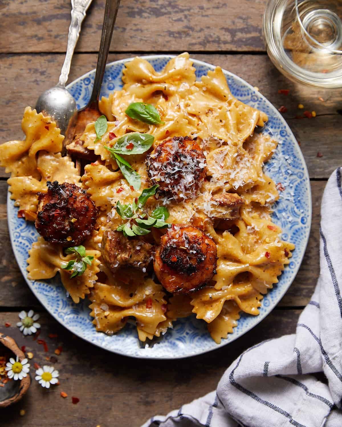 Image of creamy cajun shrimp & sausage pasta on blue plate.