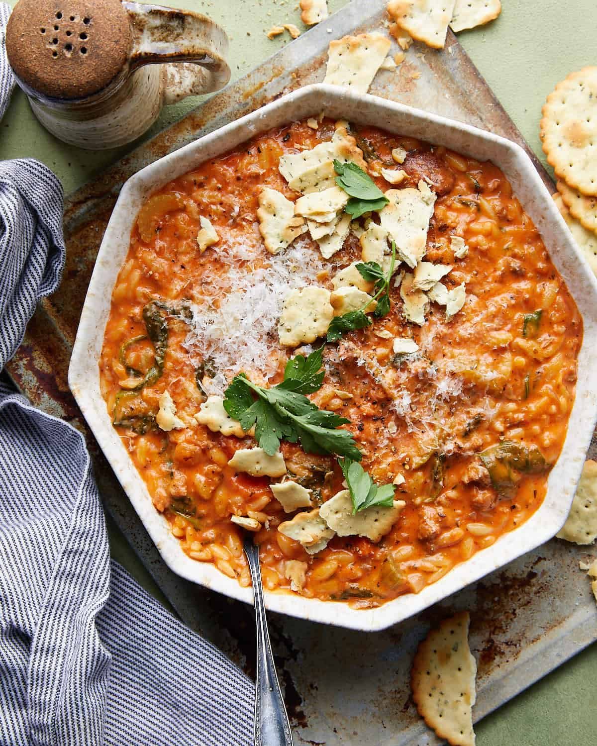 Ovehead image of creamy Italian sausage soup with garnish.