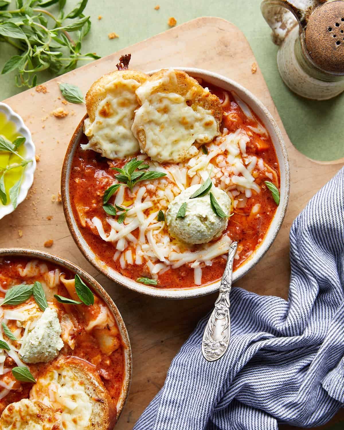 Overhead image of creamy lasagna soup with garnish.