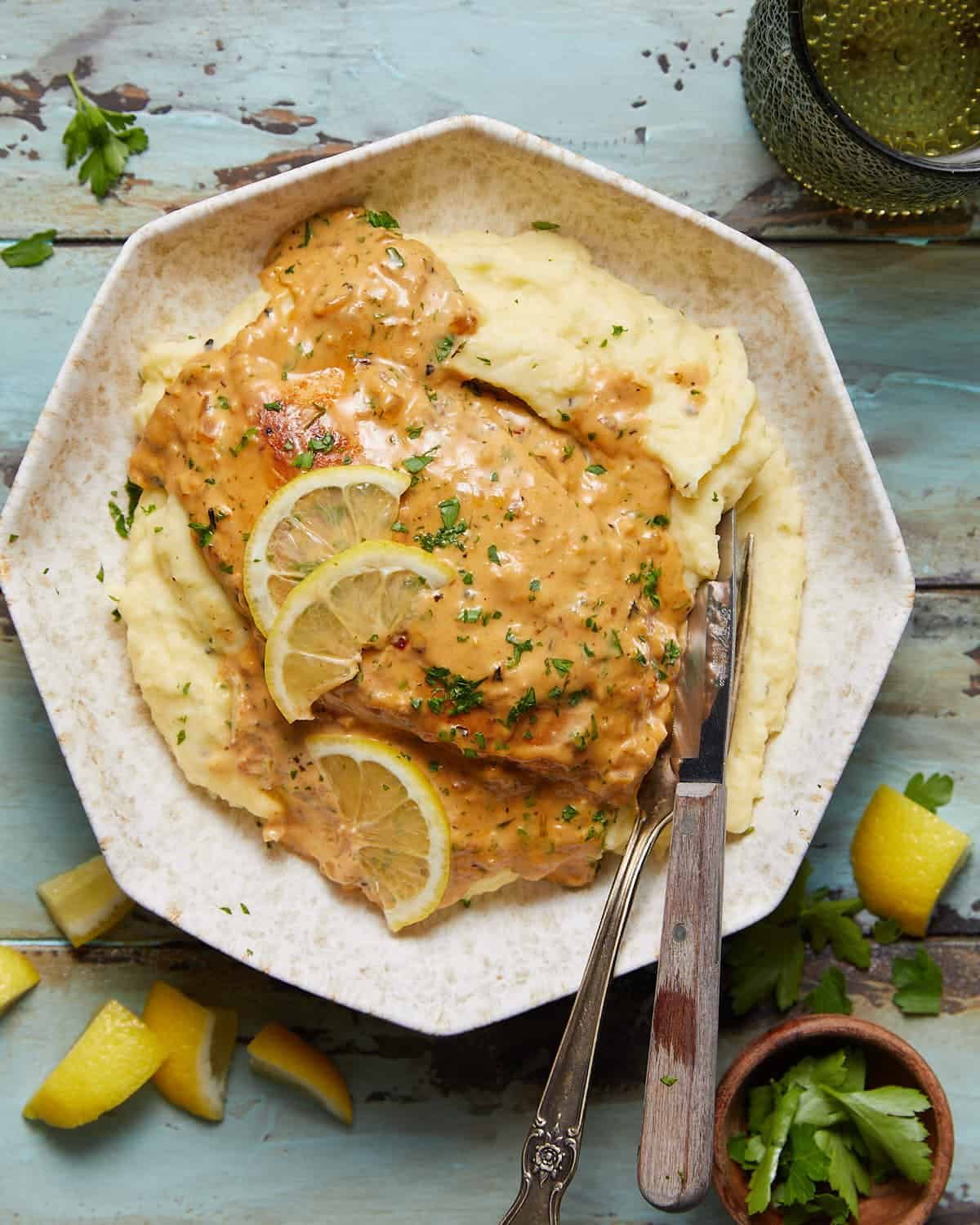 Overhead image of creamy lemon chicken with garnish.