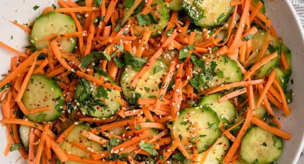 Overhead image of cucumber carrot salad with garnish.