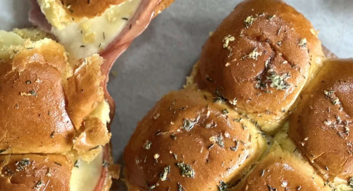 Overhead image of hot garlic butter ham and cheese sliders.