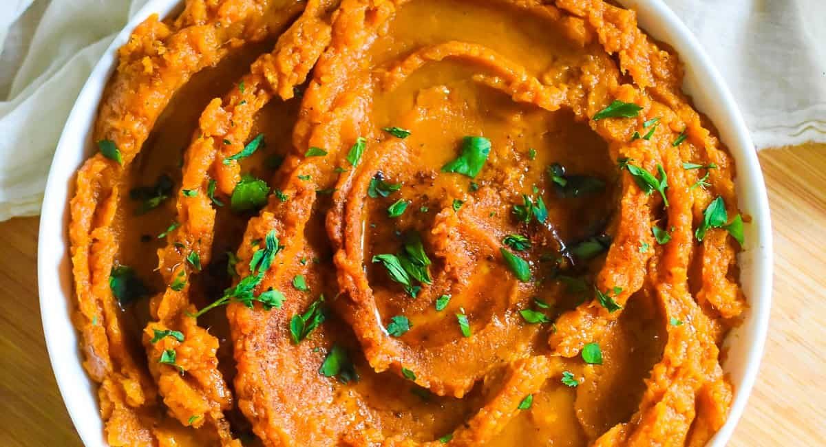 Overhead image of savory sweet potato mash with garnish.