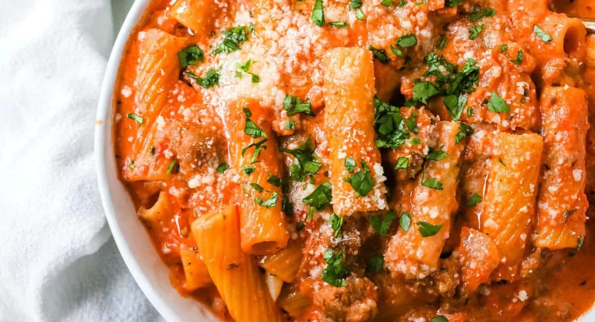 Overhead image of creamy sausage rigatoni pasta.
