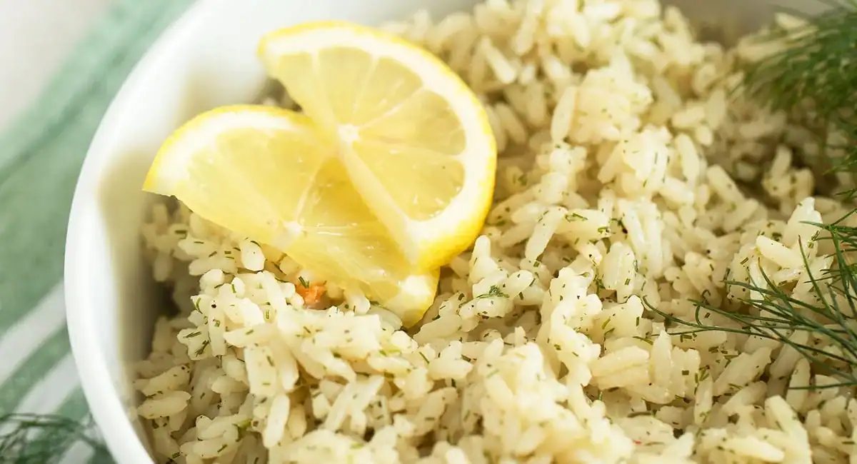 Up close image of dill lemon rice with garnish and lemon slices.