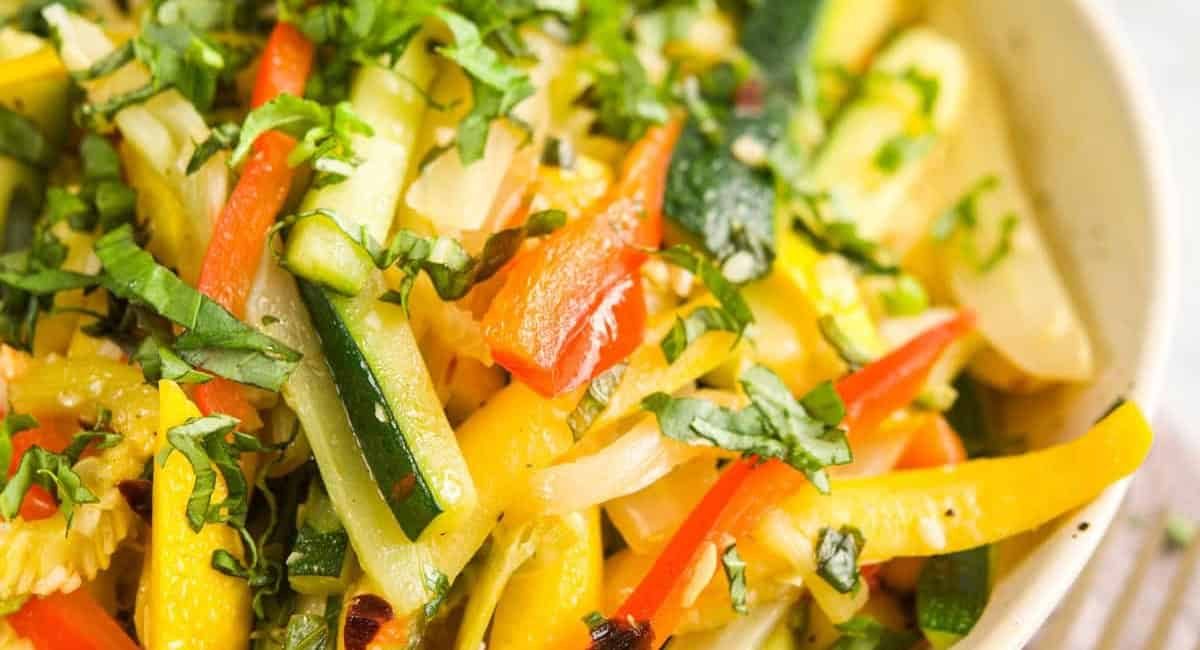 Overhead up close image of sautéed summer squash with garnish.